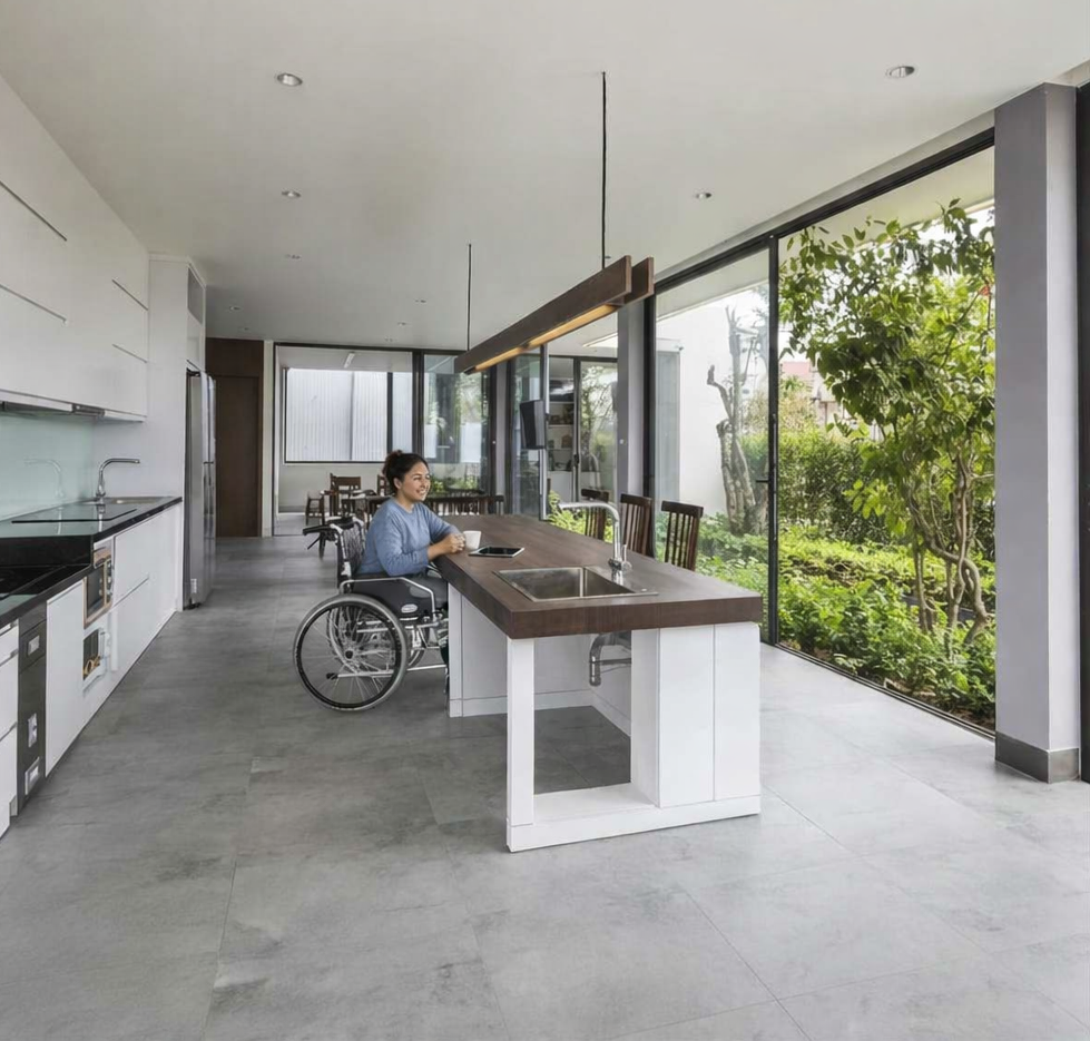 Modern kitchen with wheelchair-accessible sink and person using wheelchair
